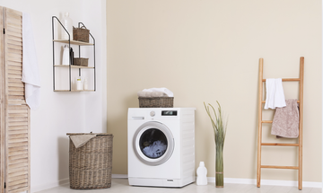 Washing machine and laundry baskets in a bright laundry room
